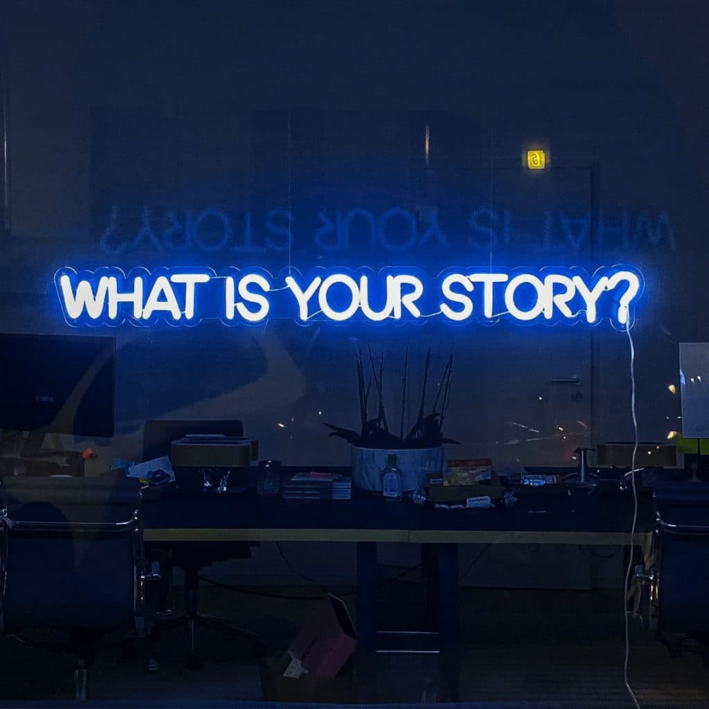 Hington Klarsey: office with light sign "what is your story"